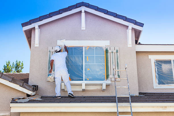 Busy House Painter Painting the Trim And Shutters of A Home. mod doors riyadh